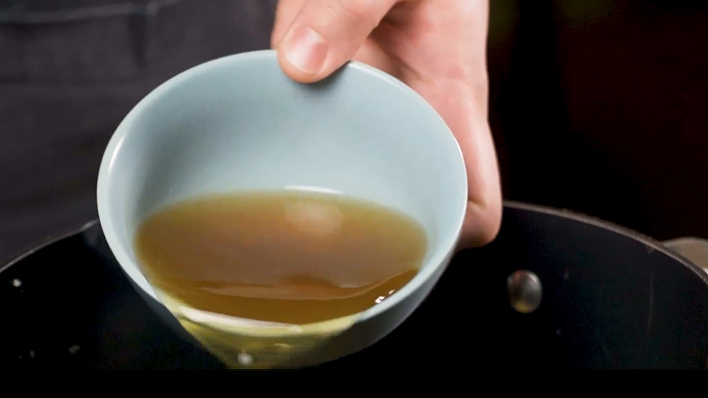 adding white wine to the pan