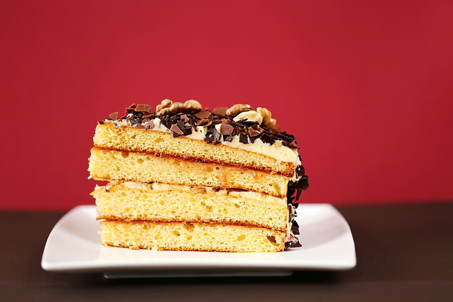 a slice of a 4-layer cake with frosting