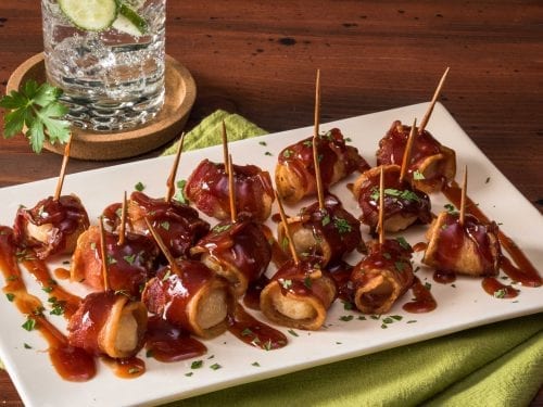 bacon-wrapped water chestnuts covered in a brown sauce