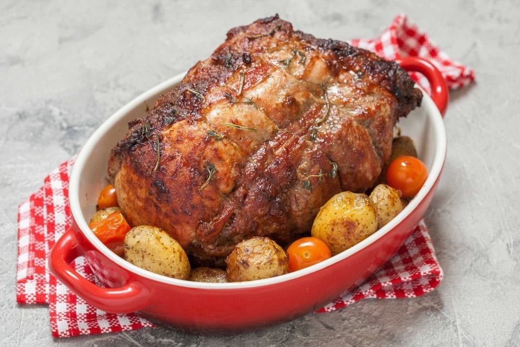 barbecued pork loin roast served with vegetables