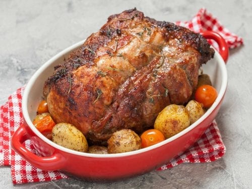 barbecued pork loin roast served with vegetables