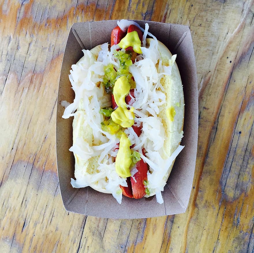 hotdog with sauerkraut in a cardboard box