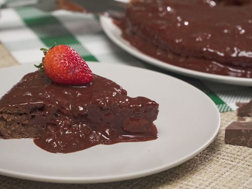chocolate stawberry sauce covered cake with strawberry on top
