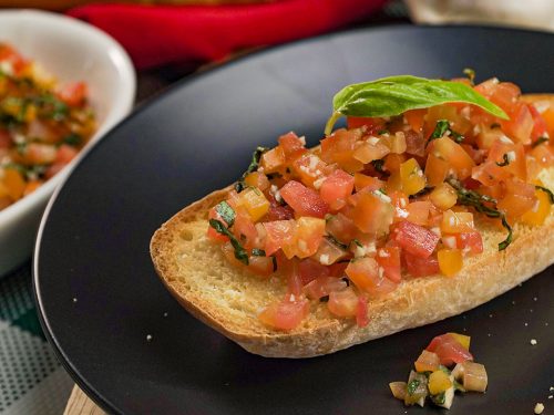 Copycat Olive Garden Bruschetta Recipe, Ciabatta bread topped with chopped tomatoes, garlic, and basil leaves