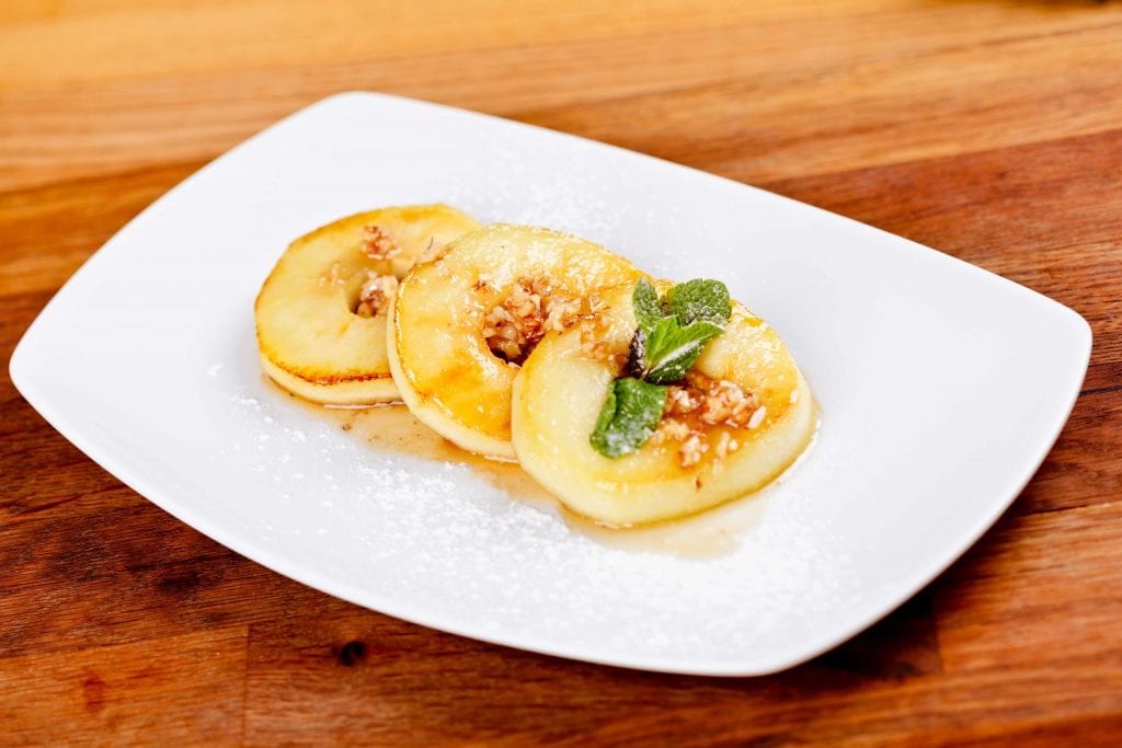 glazed apple rings on a white plate