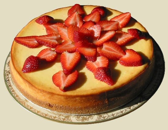 new york cheesecake covered in sliced strawberries