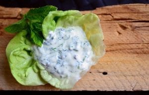 white dipping sauce on lettuce leaves