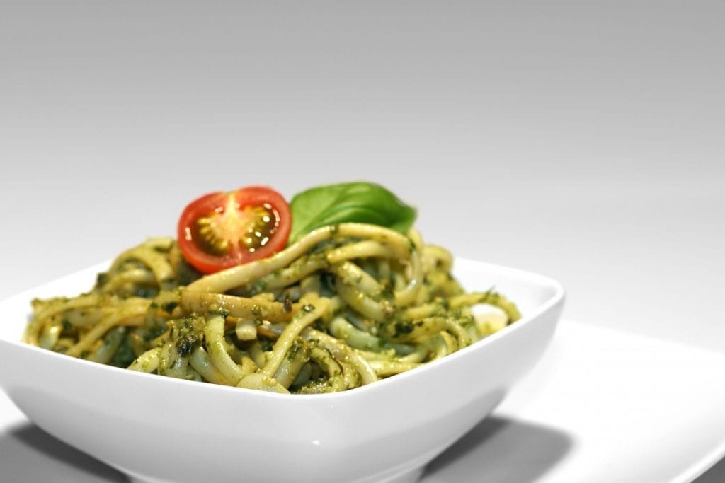 pesto pasta in a white bowl