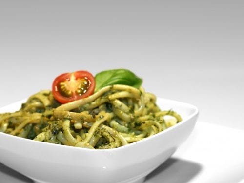 pesto pasta in a white bowl