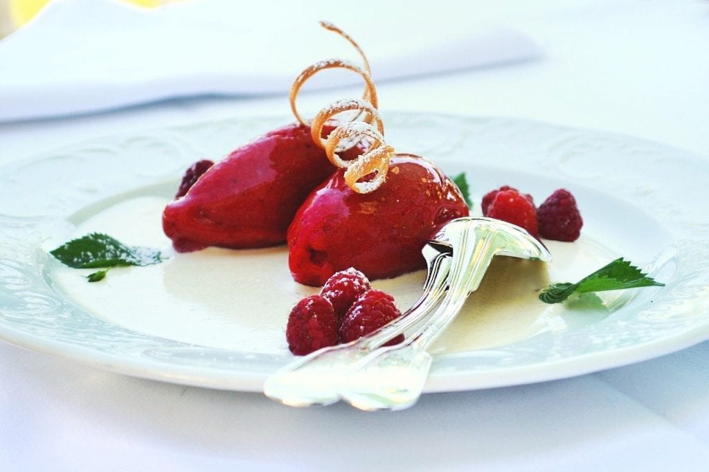 fruit sorbet garnished with zest and mint on a plate