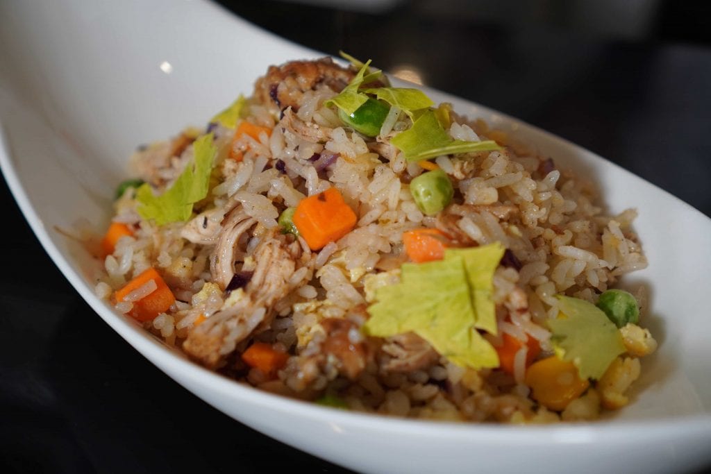 shredded chicken fried rice in a white bowl