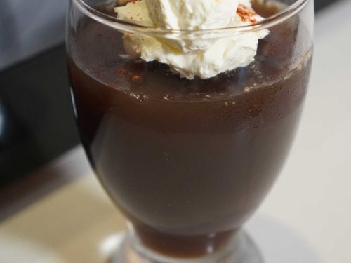 soda jelly in a glass with whipped cream and coffee granules on top