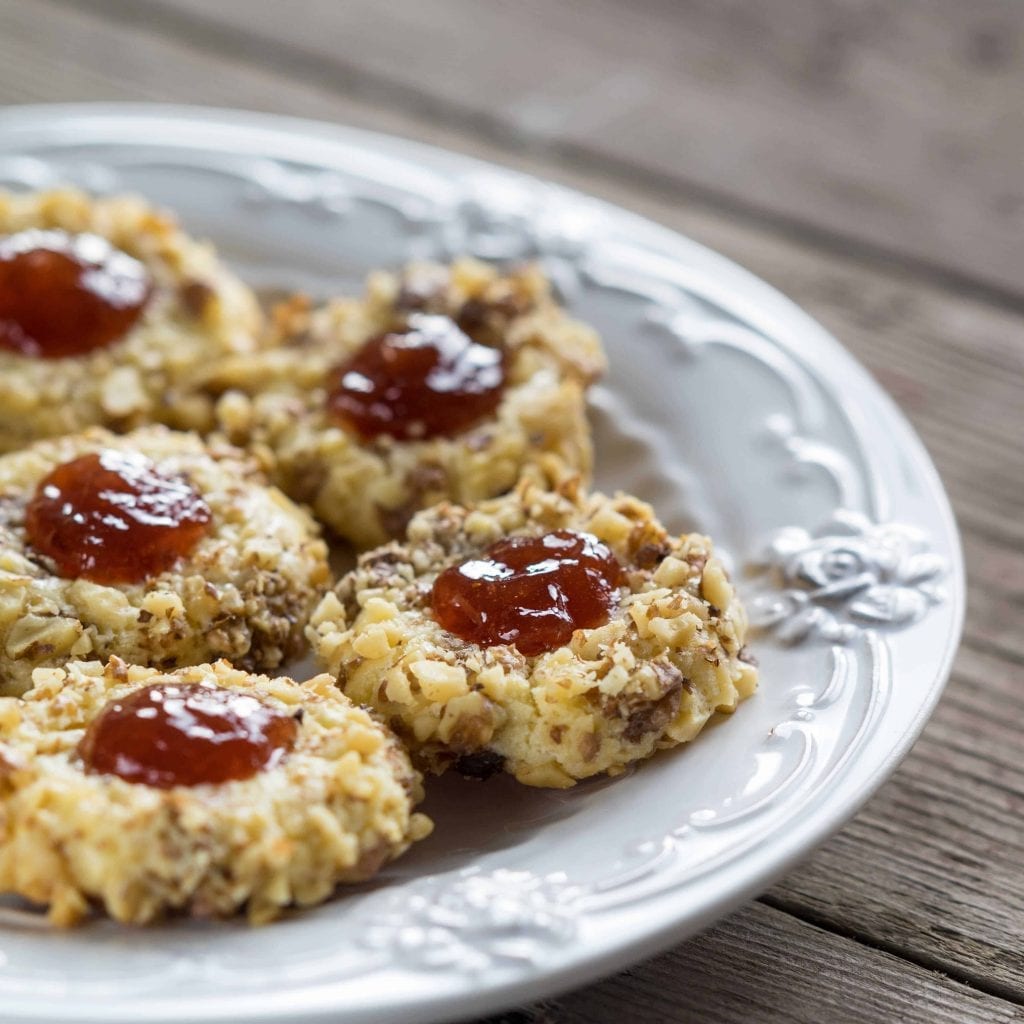 thumbprint cookies with red center and covered in nuts