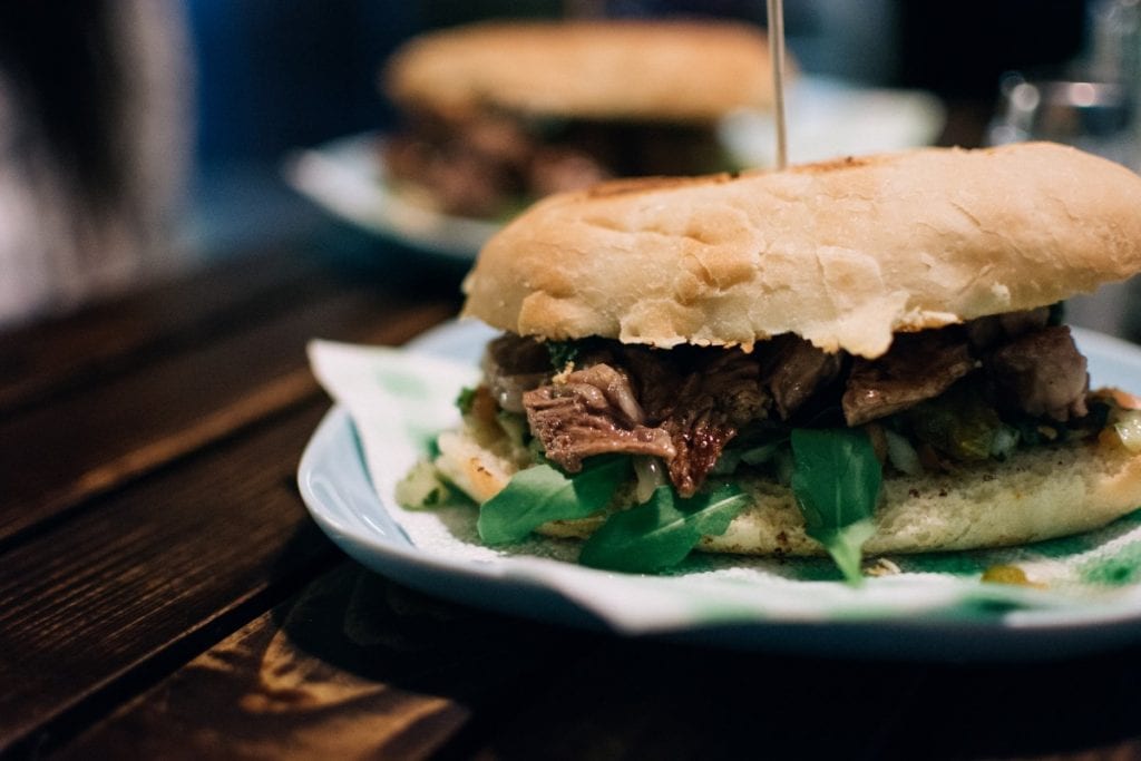 shredded beef sandwiches on white plates