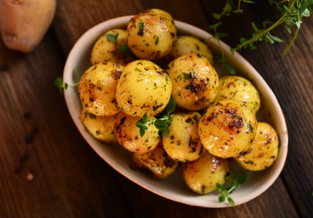 roasted young potatoes with a herb garnish