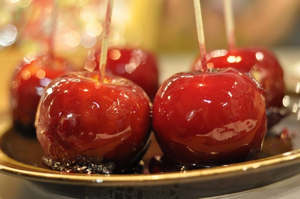 candied apples on a black plate