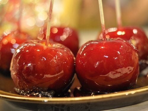 candied apples on a black plate