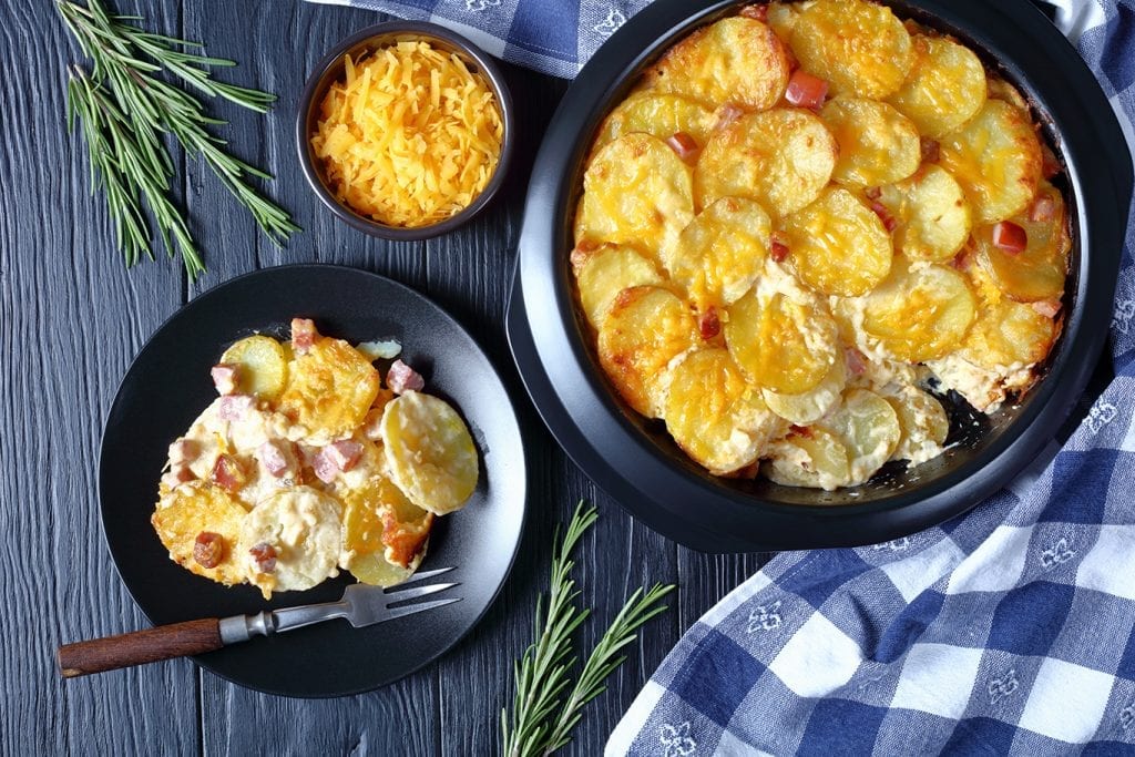 Cheesy Scalloped Potatoes and Ham Casserole Recipe, homemade scalloped potatoes and ham with cheese, sauteed onions, and milk