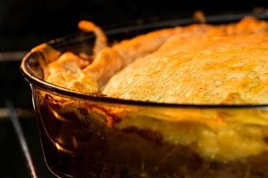 closeup of a meat pie baking in the oven