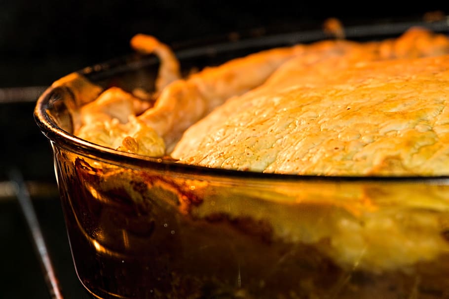 closeup of a meat pie baking in the oven