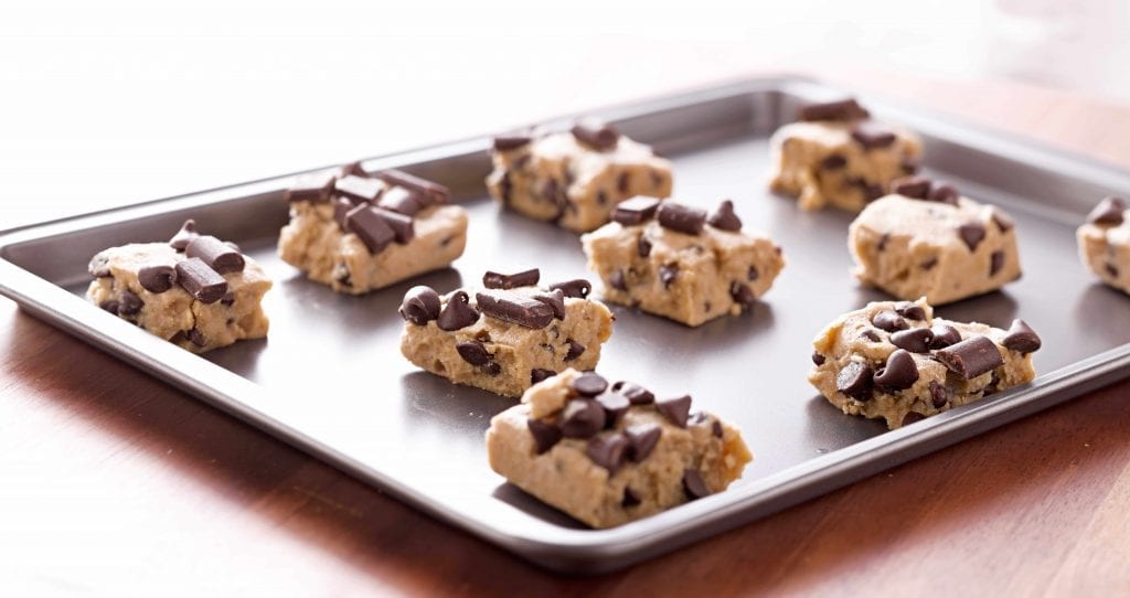 chunks of cookie dough on a baking sheet