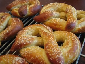 freshly baked soft pretzels on a cooling rack