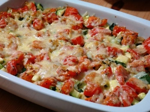 casserole covered in chopped vegetables and melted cheese