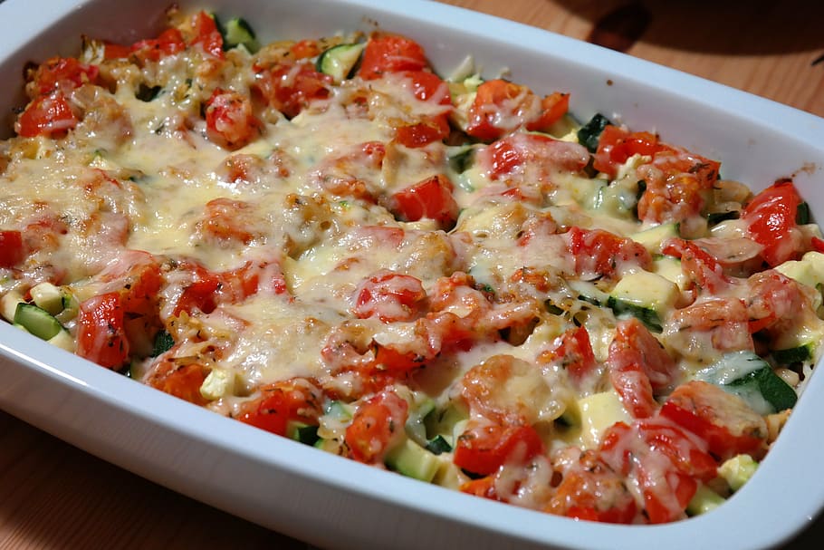 casserole covered in chopped vegetables and melted cheese