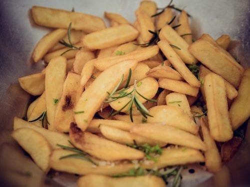 thick-cut fries with rosemary sprigs