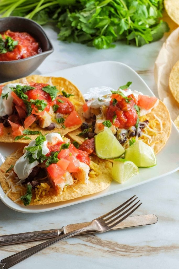 round tortillas topped with beans, tomato and cheese