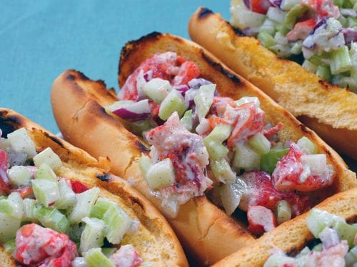 lobster salad rolls against a blue background