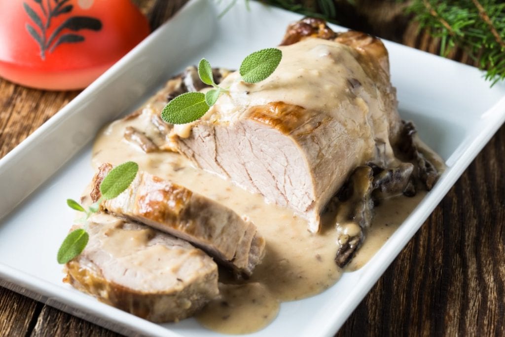 Crockpot Pork Loin Chops, piece of loin swimming in creamy mushroom soup