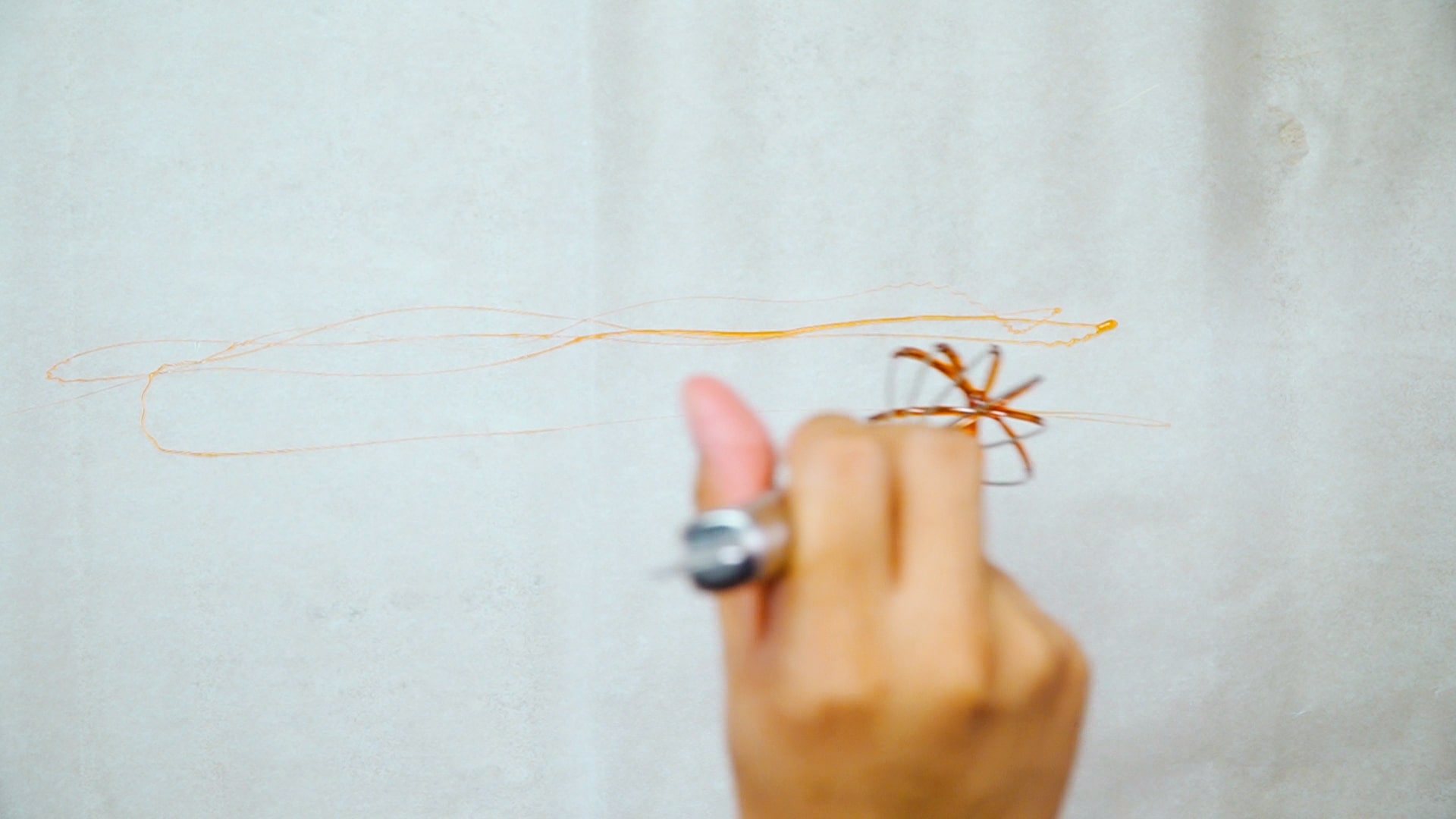 dip whisk into the sugar syrup and aim onto parchment paper