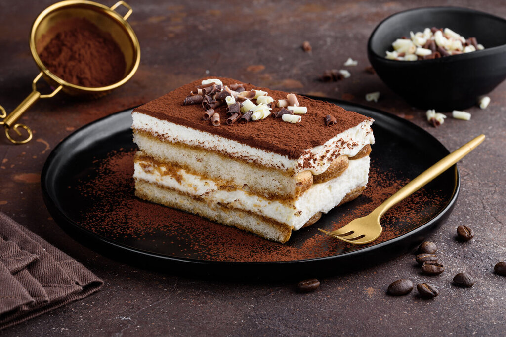 Tiramisu Cake Recipe, Tiramisu cake dessert decorated with cocoa powder and white and dark chocolate curls