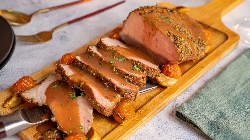 Christmas Beef Roast Recipe, Beef roast sliced and topped with port wine sauce and served on a long wooden board