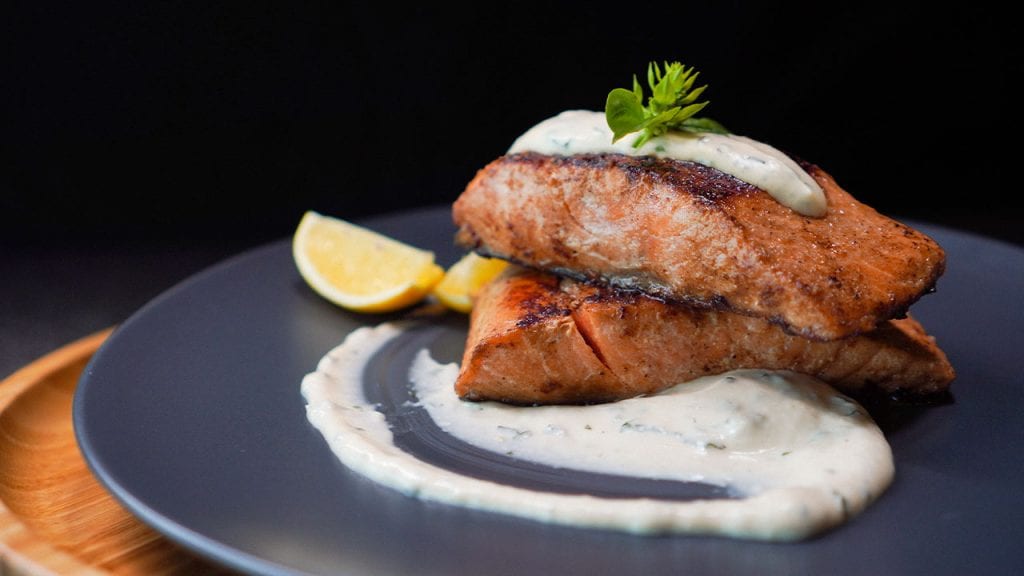 Copycat Outback Steakhouse Grilled Salmon Recipe - grilled salmon brushed with seasoned sauce and served with tartar sauce