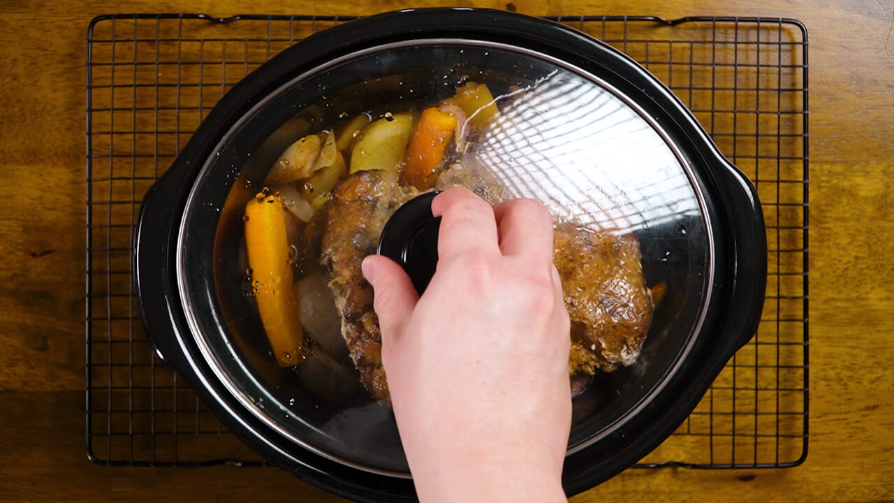 covering crockpot, crock pot pork roast with potatoes and carrots