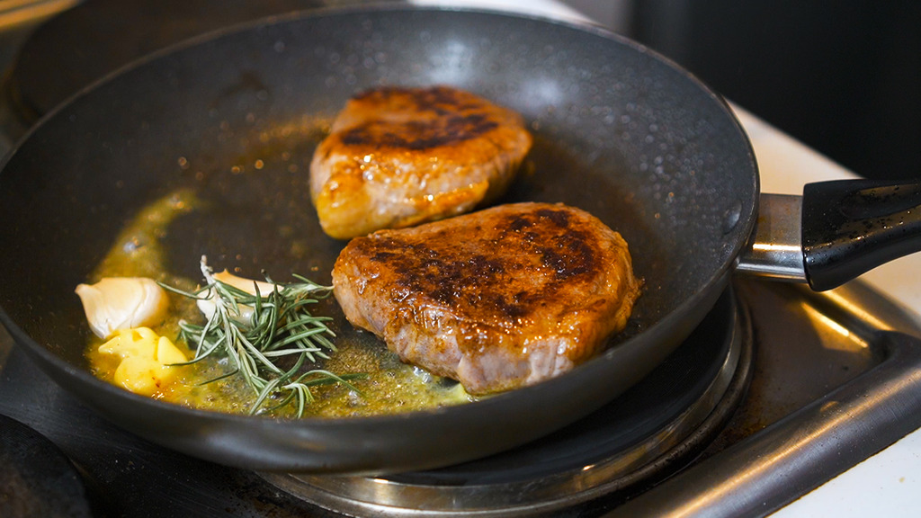 tossing in rushed garlic cloves and a few sprigs of fresh rosemary in the skillet