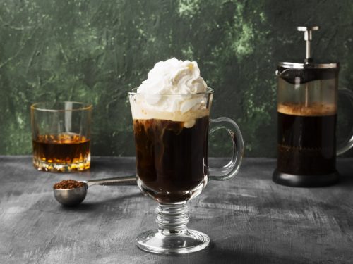 Irish coffee with whisky on dark background