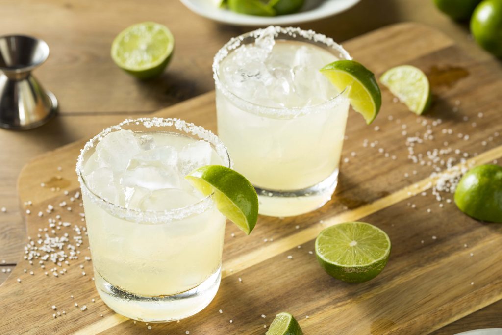 two glasses of classic margarita on a wooden table, margarita cocktail