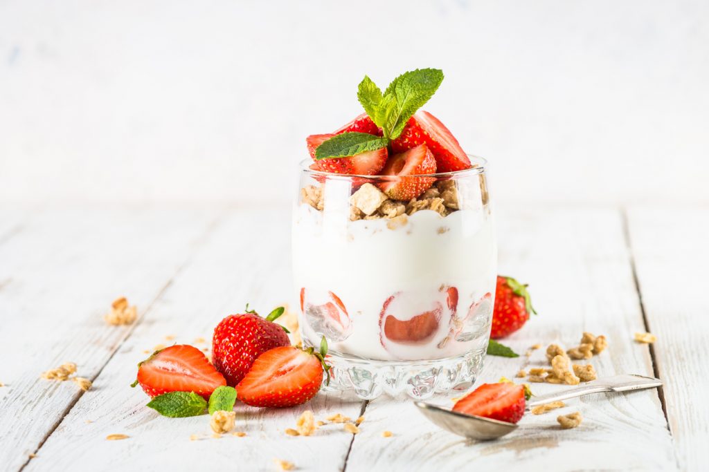 Greek yogurt with fresh strawberry and granola. Parfait.