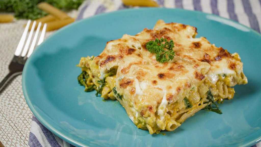 Baked Pumpkin Pasta Recipe, Penne pasta with pumpkin sauce, topped with three types of melted cheese and parsley on a blue plate