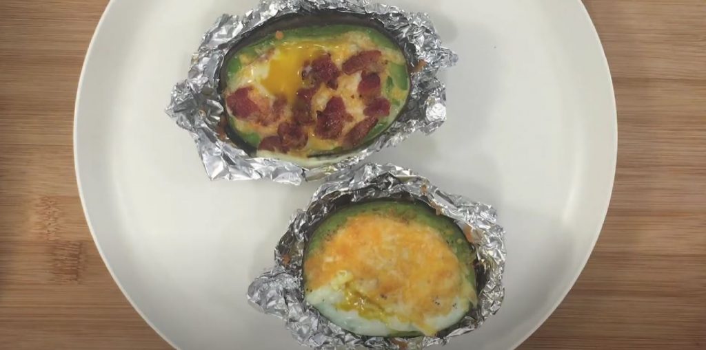 Cheesy Scrambled Eggs in Avocado With Crispy Bacon Pieces Recipe