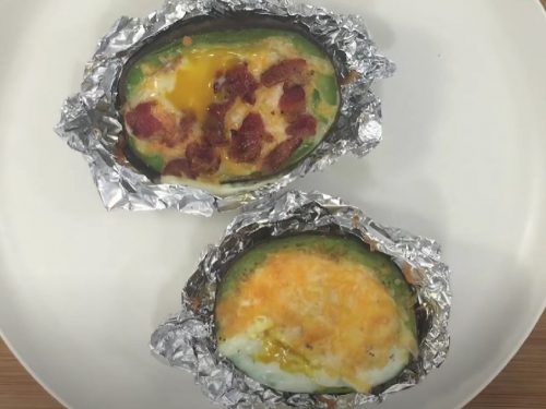 Cheesy Scrambled Eggs in Avocado With Crispy Bacon Pieces Recipe