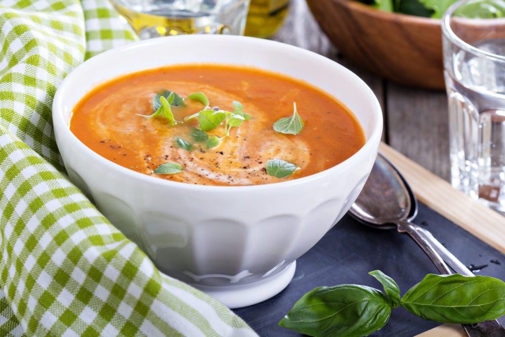 Tomato soup with cream in a white bowl