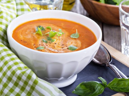 Tomato soup with cream in a white bowl