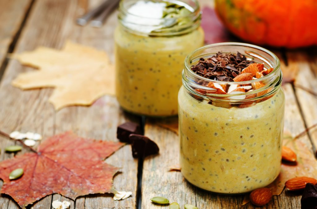 Jar filled with pumpkin-flavored overnight oats and chia seeds.