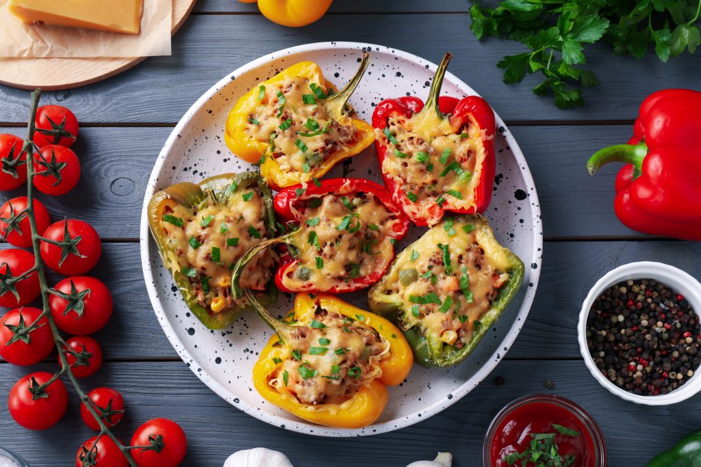 tasty stuffed bell peppers on wooden table