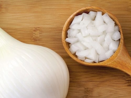 onion slices in a wooden spoon