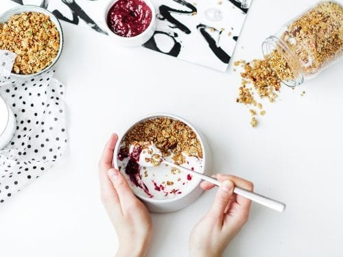 yogurt, yogurt in a bowl scooped with a spoon, yogurt with nuts and fruit preserves, eating yogurt